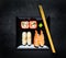 Sushi With Caviar and Sashimi on Black Plate with Chopsticks