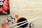 Sushi chopsticks over soy sauce bowl, salmon rolls