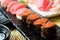 Sushi with chopsticks and soy sauce. Sushi roll japanese food in restaurant. Salmon roe Sushi set with salmon, vegetables, flying