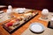 Sushi in Japanese Food Restaurant â€“ Plate with Soy Sauce, Chopsticks, Row of Nigiri and Rolls with Wasabi, Red Caviar