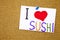 Sushi love sushi sticky note pinned to a cork notice