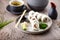Sushi maki rolls Philadelphia with salmon, creamy cheese and avocado on a plate with chopsticks, soy sauce, wasabi and