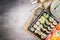Sushi menu with summer rolls, nigiri , soy sauce and miso soup on gray stone background, top view, place for text