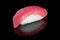 Sushi nigiri with tuna on black background with reflection. Japa