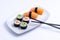 Sushi plate on white background. Makizushi. Delicious sushi rolls on white plate with chopsticks and wasabi. Maki