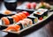 Sushi plate on a wooden table, blurred background.