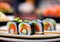 Sushi plate on a wooden table, blurred background.