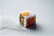a sushi roll with a colorful sushi design on it\\\'s side and a pile of white rice on the side