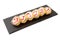 Sushi Roll with cream cheese above and Fresh fish and Avocado on a slate slab on white background