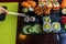 Sushi roll eating with chopstick. Sushi set restaurant. Black background.