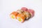 Sushi roll with raw salmon fillet, tuna and unagi eel on top  isolated on white background