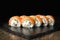 Sushi roll with salmon, smoked eel, avocado, cream cheese on black background. Sushi menu. Japanese food.