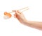 Sushi roll with wooden chopsticks in female hand on white background