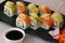 Sushi rolls with avocado, crab, salmon and soy sauce