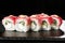 Sushi Rolls with cucumber, tuna, and Cream Cheese inside on black slate isolated. Philadelphia roll sushi with shrimp