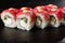 Sushi Rolls with cucumber, tuna, and Cream Cheese inside on black slate isolated. Philadelphia roll sushi with shrimp