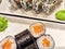 Sushi rolls with fresh ingredients served on a platter. Japanese Sushi Rolls on White Plate With Ginger Garnish. Blurred