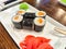 Sushi rolls with fresh ingredients served on a platter. Japanese Sushi Rolls on White Plate With Ginger Garnish. Blurred