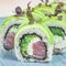 Sushi Rolls With Green and White Toppings on a Blue Plate