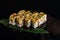 Sushi rolls japanese food over black background. Sushi roll with salmon, tofu, vegetables and avocado closeup. Japan restaurant