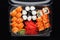 Sushi rolls mix in a plastic box container