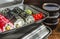 Sushi rolls in a plastic thermo container