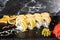 Sushi Rolls with processed cheese, cheddar, american cheese, avocado, mango and Cream Cheese inside on black slate isolated on