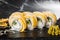 Sushi Rolls with processed cheese, cheddar, american cheese, avocado, mango and Cream Cheese inside on black slate isolated on