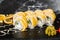 Sushi Rolls with processed cheese, cheddar, american cheese, avocado, mango and Cream Cheese inside on black slate isolated on