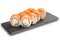 Sushi Rolls with salmon, cucumber, nori leaf and Cream Cheese inside on black slate or stone shale surface isolated