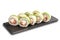 Sushi Rolls with salmon, cucumber, nori leaf and Cream Cheese inside on black slate or stone shale surface isolated