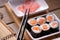 Sushi rolls with salmon, ginger and chopsticks