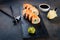 sushi rolls on stone plate with sauces, chopsticks, ginger and wasabi
