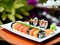 Sushi rolls on a whote plate in the garden, asiatic food