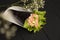 Sushi Sake Temaki with salmon, rice, Tobiko caviar, avocado, salad leaf in nori seaweed on plate. White flowers on background