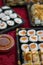 Sushi salmon hosomaki take-away box, Japanese food, and bowl of sauce