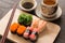 Sushi set with chop sticks and soy sauce served on wooden slate