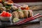 Sushi set food photo. Rolls served on brown wooden and slate plate. Close up of sushi