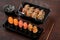 Sushi set of gunkan maki and rolls with eel in plastic boxes