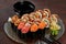Sushi set of gunkan maki and rolls with eel on platter