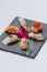 Sushi Set Include Torched Salmon, Engawa, Hotate, Hamachi, Tai and Ikura with Hirame Served with Wasabi and Prickled Ginger.