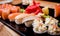 Sushi set. Rolls with salmon, eel and red caviar on a wooden plate. Restaurant.