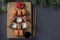 Sushi set of salmon, tuna and eel as Christmas tree served on a wooden board as Xmas decoration on a dark background