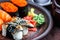 Sushi Set sashimi and sushi rolls served on dark plate. Image of Japanese food on dark background.