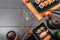 Sushi set sashimi and sushi rolls and tomatoes served on dark background