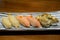 Sushi Set sashimi and sushi, squid, salmon, shell served on stone slate