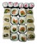 Sushi set on a white background, isolate, top view. Maki sushi with cheese and caviar, rolls with sesame, mussels, red fish and