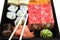 Sushi on square tray isolated front view closeup