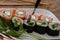 Sushi strung with a fork, Japanese rolls, fish and rice,