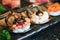 Sushi topped with Sliced salmon, foie gras, salmon egg and black tobiko